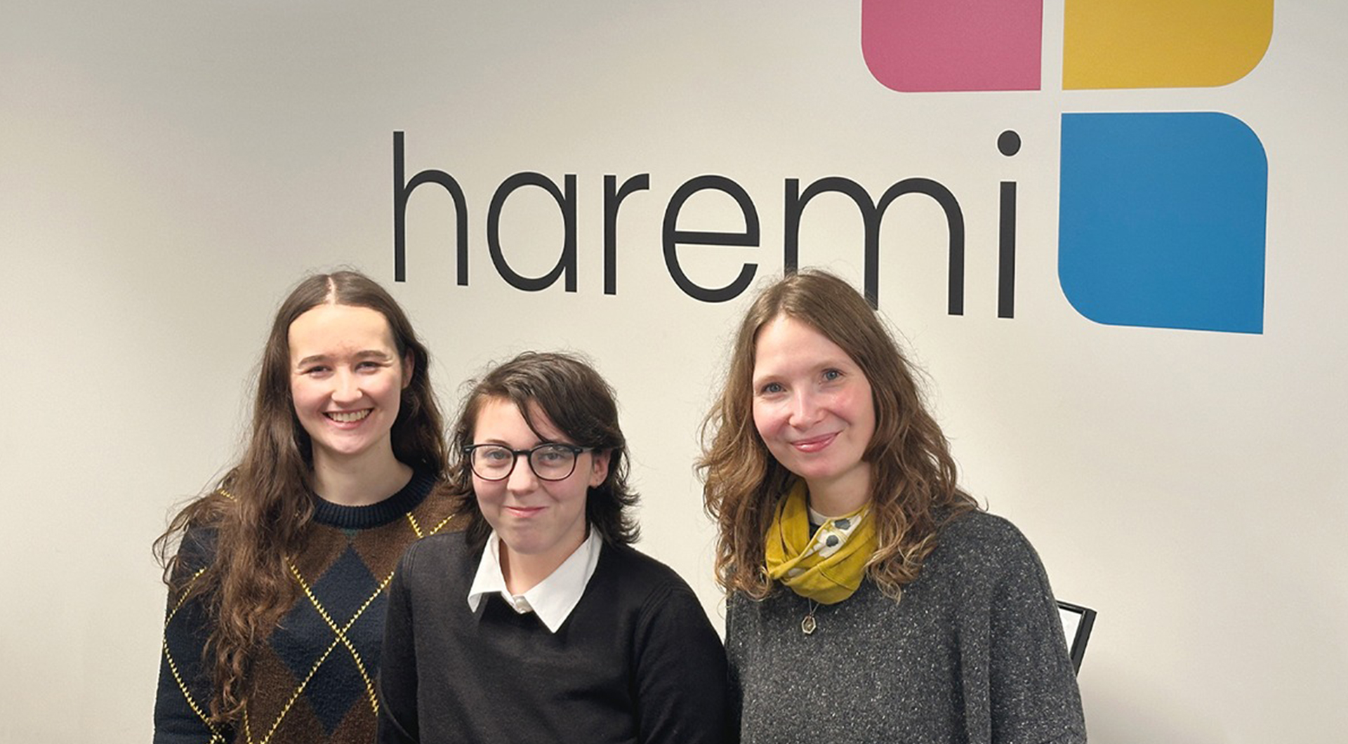 A teacher helping a student at a desk.