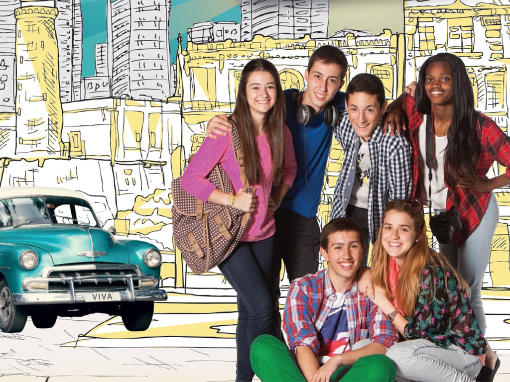A group of teenage children posing for a photo in front of a hand drawn background featuring Spanish architecture